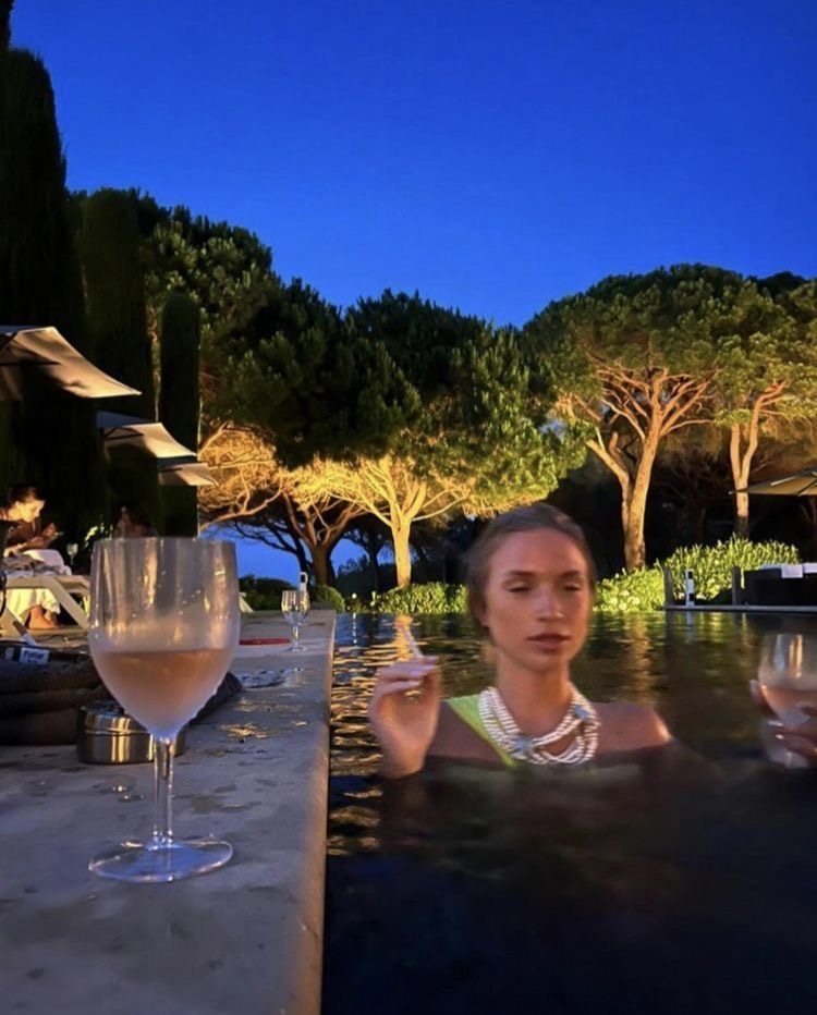 Pearls and champagne in the pool at dusk